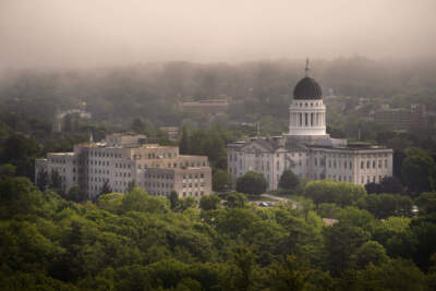 The morning fog lifts beyond the Burton M. Cross Building, left, and the State House, Wednesday, June 21, 2023, in Augusta, Maine. (Robert F. Bukaty/AP)