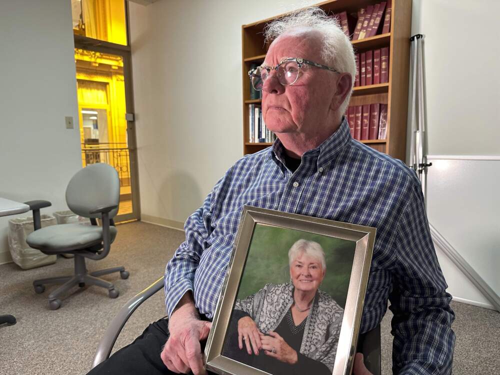 Michael Kruzich holds a photo of his late mother Donna during an interview in Lansing, Mich. Donna Kruzich was one of dozens of people in the U.S. who died after being injected with tainted steroids made by a specialty pharmacy in Massachusetts. (Mike Householder/AP)