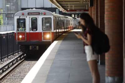 A Red Line train arrives at JFK/UMass station. (Michael Dwyer/AP)