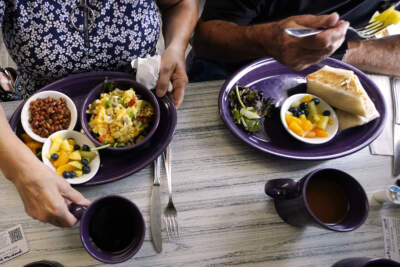Two people eat breakfast in New Hampshire. (Charles Krupa/AP)