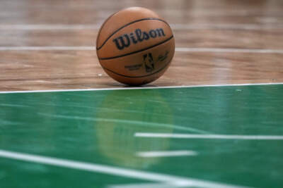 A basketball rests on the parquet floor of the TD Boston Garden during an NBA basketball game, Wednesday, Jan. 10, 2024, in Boston. (AP Photo/Charles Krupa)