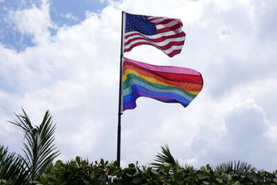 An American flag flies with a pride flag. (Lynne Sladky/AP)