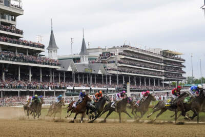Javier Castellano, atop Mage, third from left, is seen with others behind the pack as they make the first turn while competing in the 149th running of the Kentucky Derby horse race at Churchill Downs in 2023. (Julio Cortez/AP)