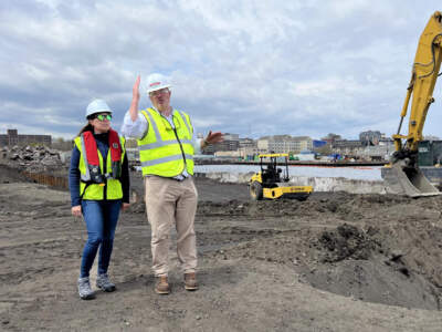 Andrew Saunders, president of the Foss Marine Terminal in New Bedford, walks the property with Alicia Barton, CEO of Vineyard Offshore, who was visiting for the first time. Vineyard Offshore plans to base operations and maintenance for Vineyard Wind 2 at the terminal. (Jeanette Barnes/CAI)