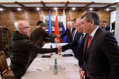 Ukrainian Defence minister Oleksii Reznikov (L) shakes hands with Russian negotiators prior the talks between delegations from Ukraine and Russia in Belarus' Brest region on March 3, 2022, following the Russian invasion of Ukraine.  (MAXIM GUCHEK/BELTA/AFP via Getty Images)