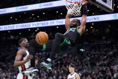 Boston Celtics guard Jaylen Brown, right, slams a dunk against Miami Heat center Bam Adebayo (13) during the first half of Game 5 of an NBA basketball first-round playoff series, Wednesday, May 1, 2024, in Boston. (Charles Krupa/AP)
