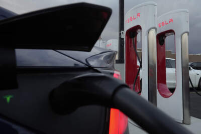 FILE - A vehicle charges at a Tesla Supercharger station in Detroit, Nov. 16, 2022. (Paul Sancya/AP)