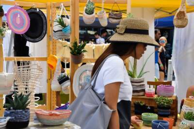 A person browses at a booth at SoWa Open Market. (Photo courtesy of SoWa Boston)